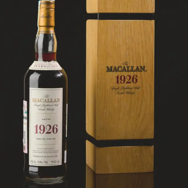 The Macallan 1926 60-year-old single malt Scotch whisky bottle beside its wooden presentation case