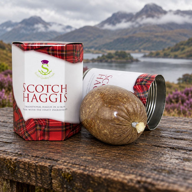 Stahly Scotch haggis with its tartan packaging on a rustic wooden table overlooking a Highland loch and mountains.