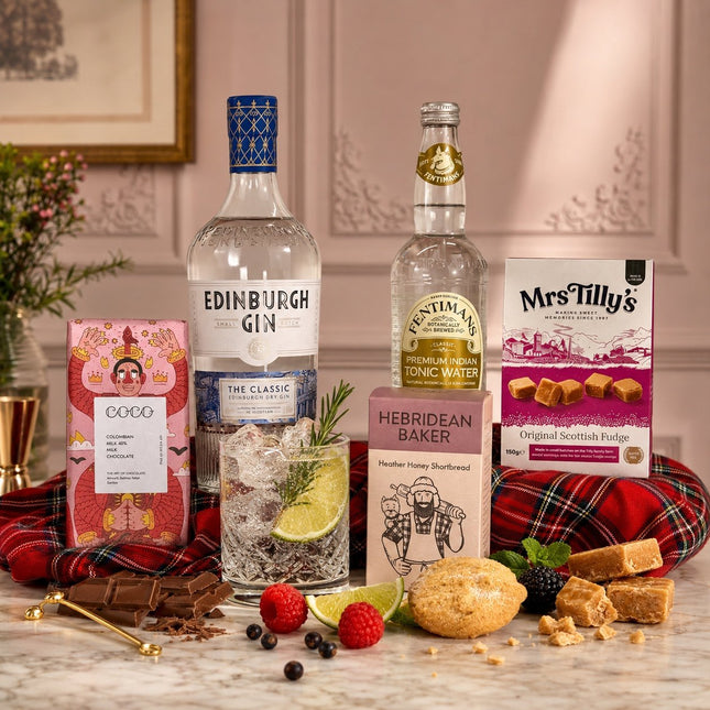 Bottles of Edinburgh Gin and Hebridean Baker tonic water with a glass of gin and tonic on a table.