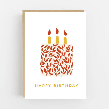 Happy birthday greeting card with a red leaf-patterned cake, three yellow candles and a kraft envelope.