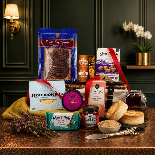 Assorted food products including cookies, jam, and honey on a wooden table with a dark green wall background.
