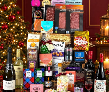 Scottish Festive Feast Hamper with cheeses, smoked meats, sweet treats, wine, prosecco and port in a Christmas setting