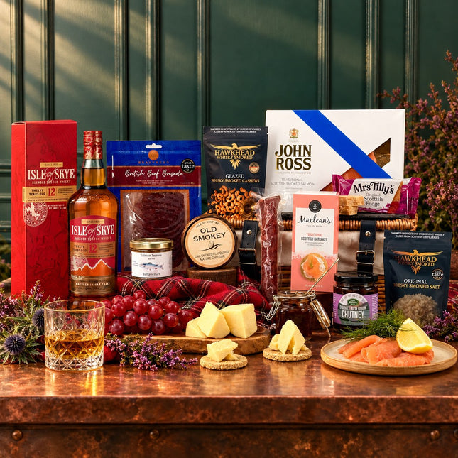 Isle of Skye 12 Year Old whisky with smoked salmon, cheese, cured meats, oatcakes and fudge arranged around a wicker hamper.
