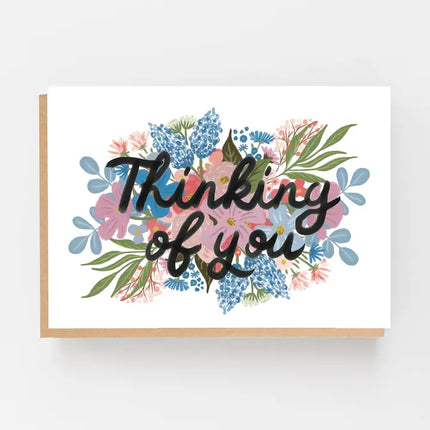 Thinking of you greeting card with pink and blue flowers and a kraft envelope.